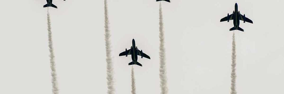 Japanese fighter jets perform maneuvers in flight formation for military drills.