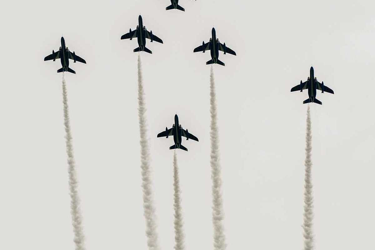 Japanese fighter jets perform maneuvers in flight formation for military drills.