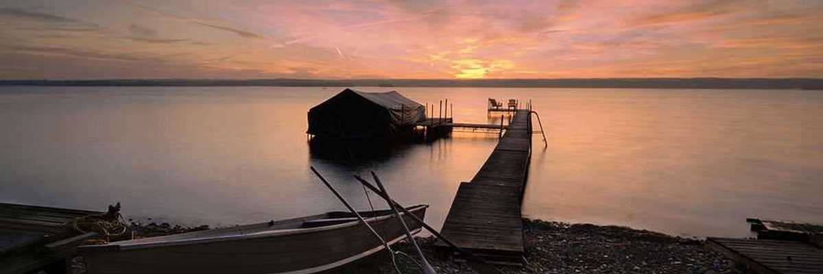 Lake Cayuga dock with sunset in the background