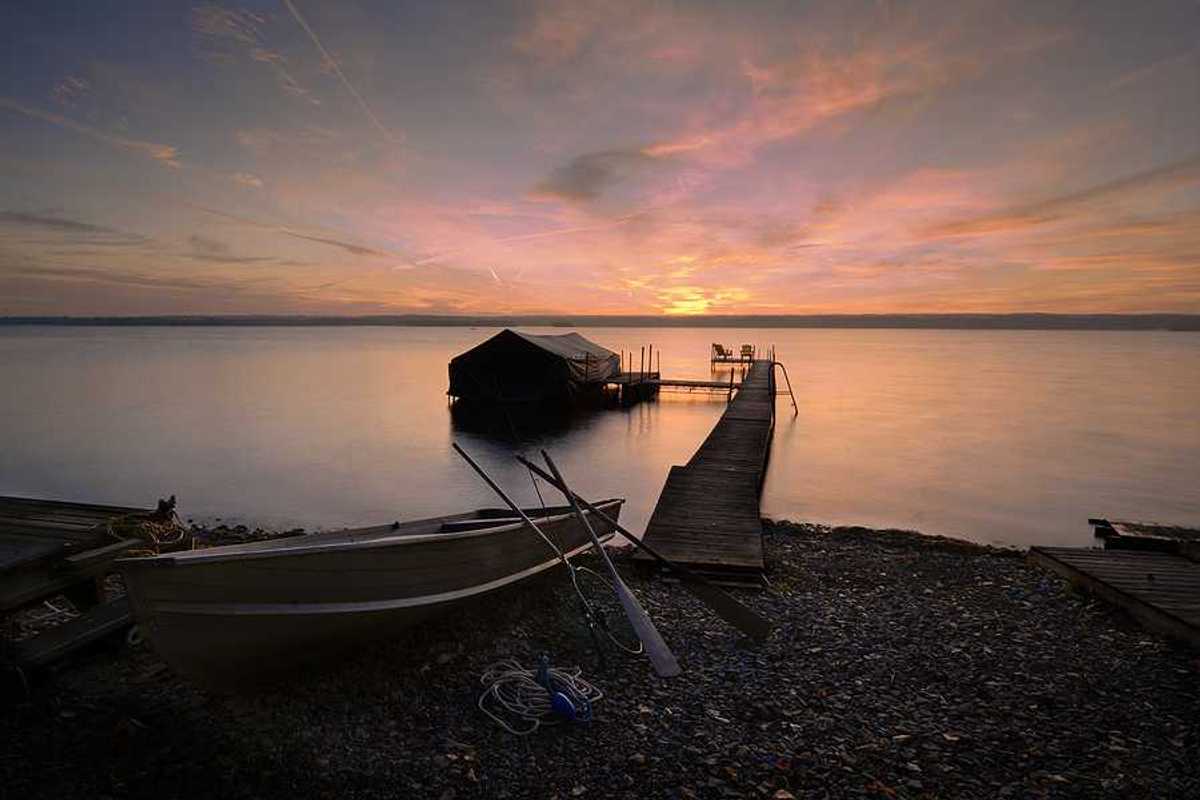 Lake Cayuga dock with sunset in the background