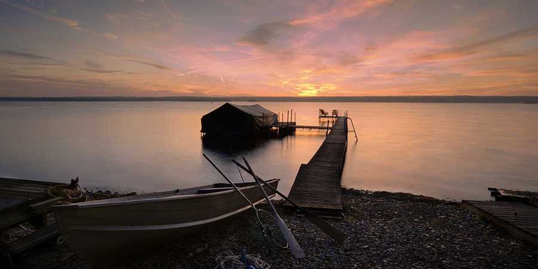 Lake Cayuga dock with sunset in the background
