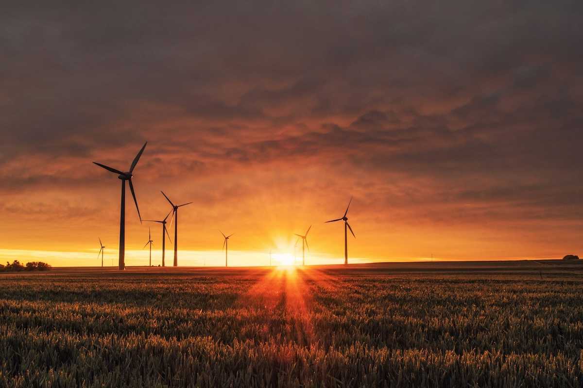 Land-based wind turbines against a rising sun
