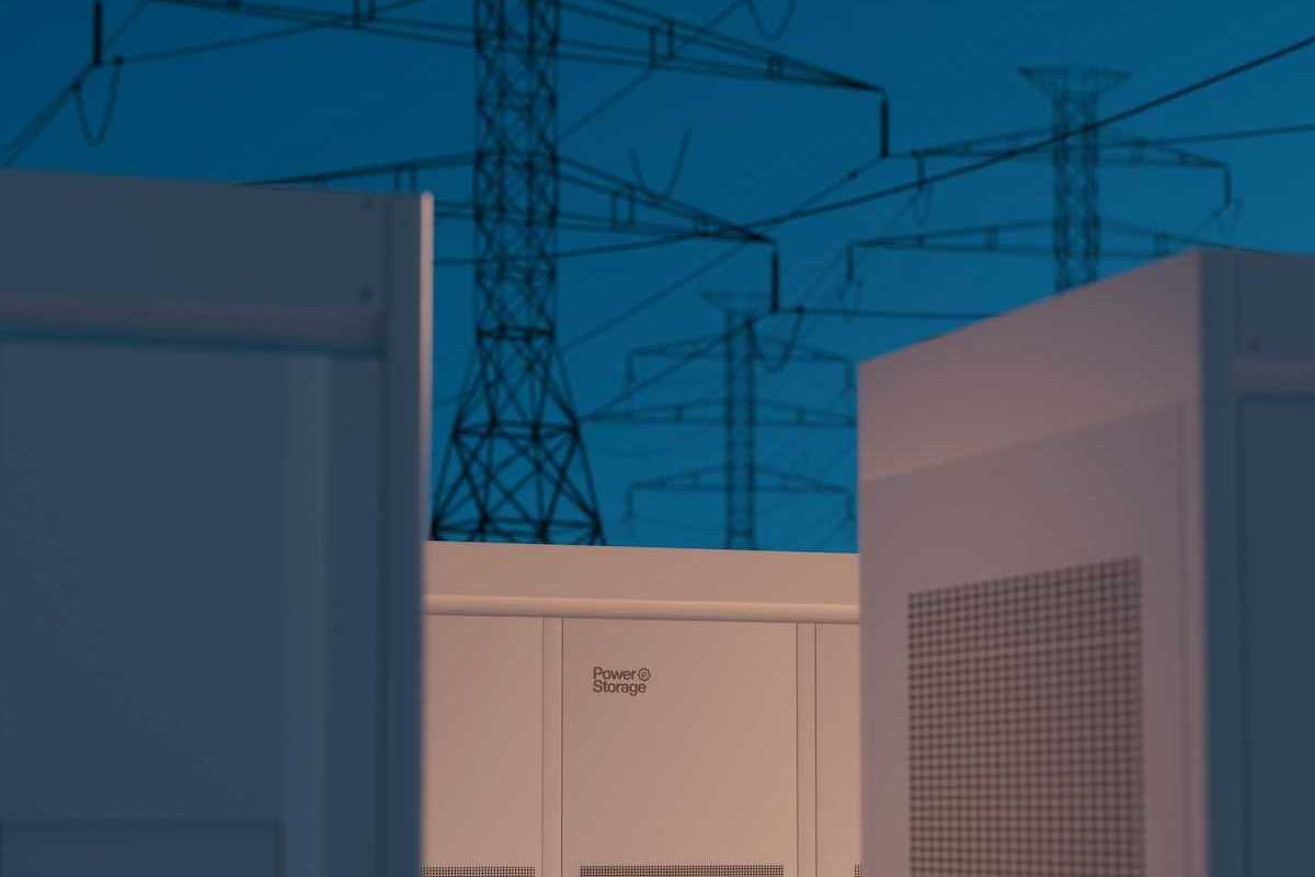 Large storage batteries with transmission lines in background