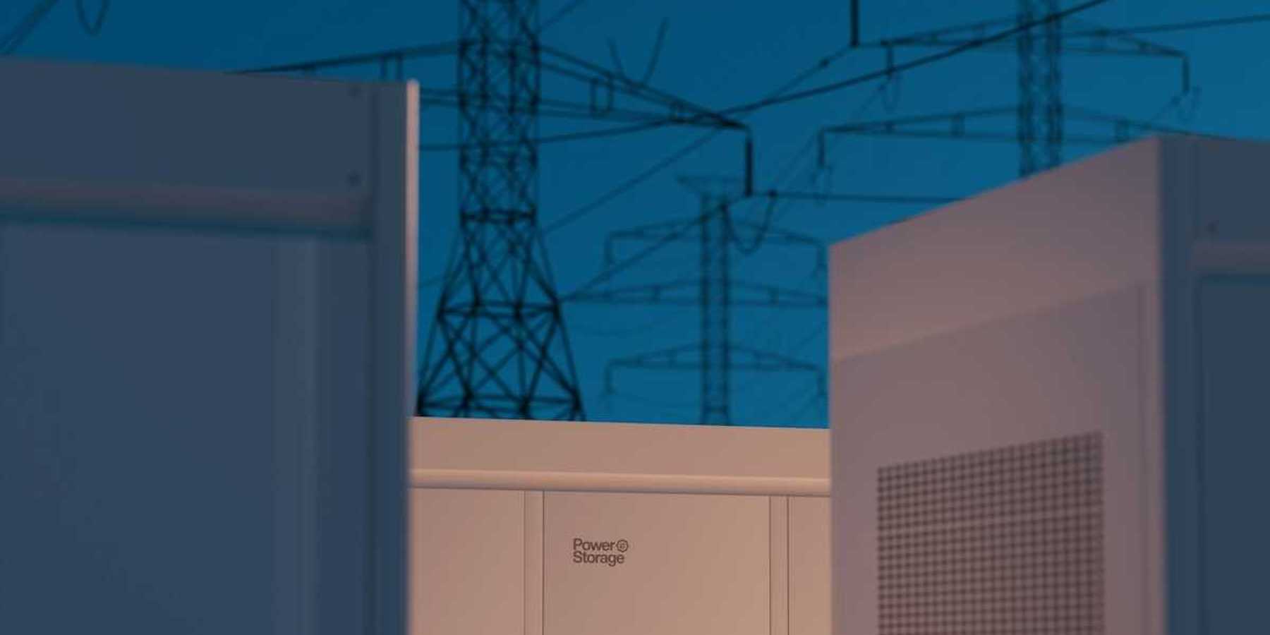 Large storage batteries with transmission lines in background