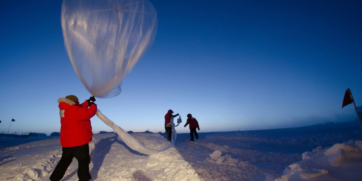 Launching an ozonesonde balloon in a snowy landscape.