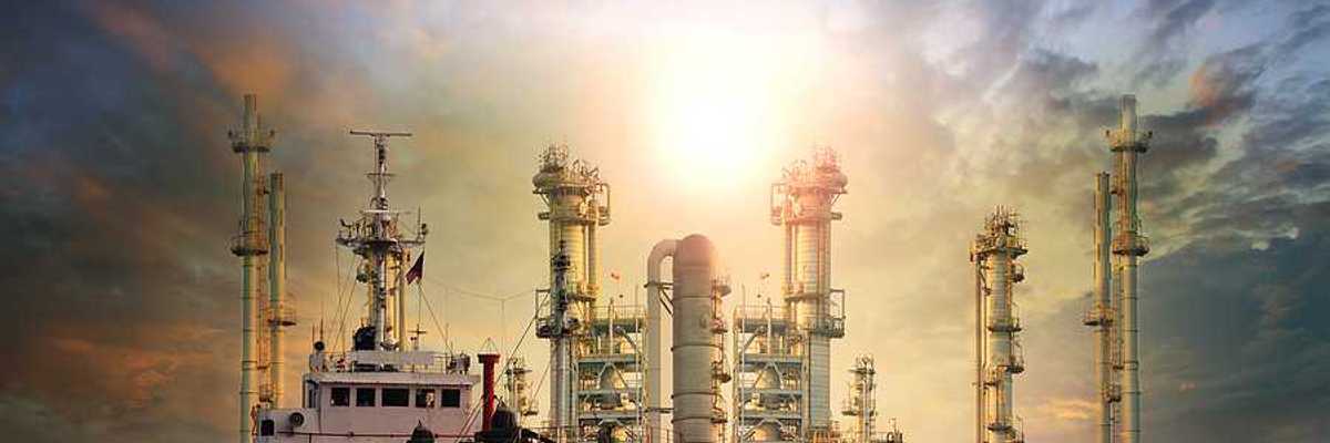 LNG tanker ship with oil & gas refinery plant in background