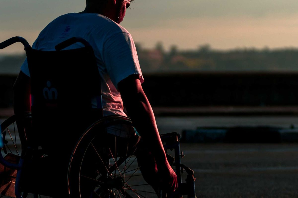 man sitting in wheelchair during daytime.
