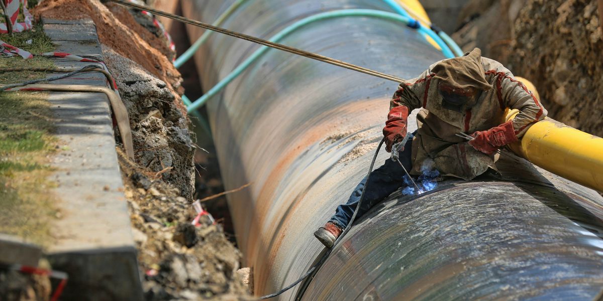 Man working on a pipeline in a trench.