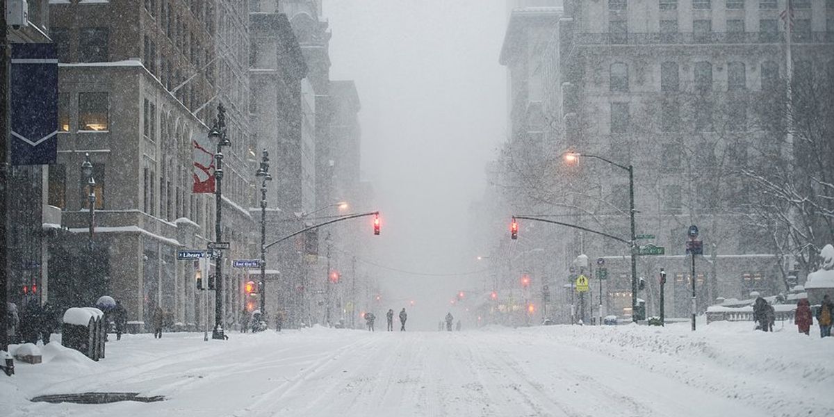 Manhattan street covered in snow during a blizzard.