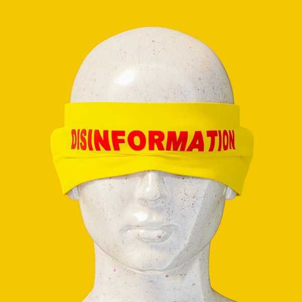 Mannequin headshot wearing a yellow blindfold labeled "disinformation" in red letters
