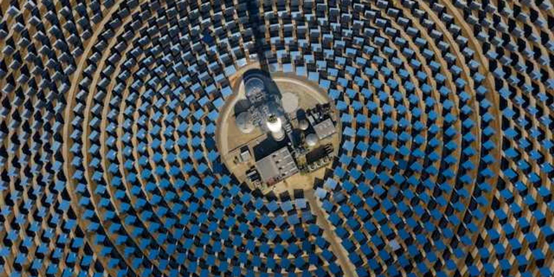 Many solar panels arranged in a circular pattern viewed from above