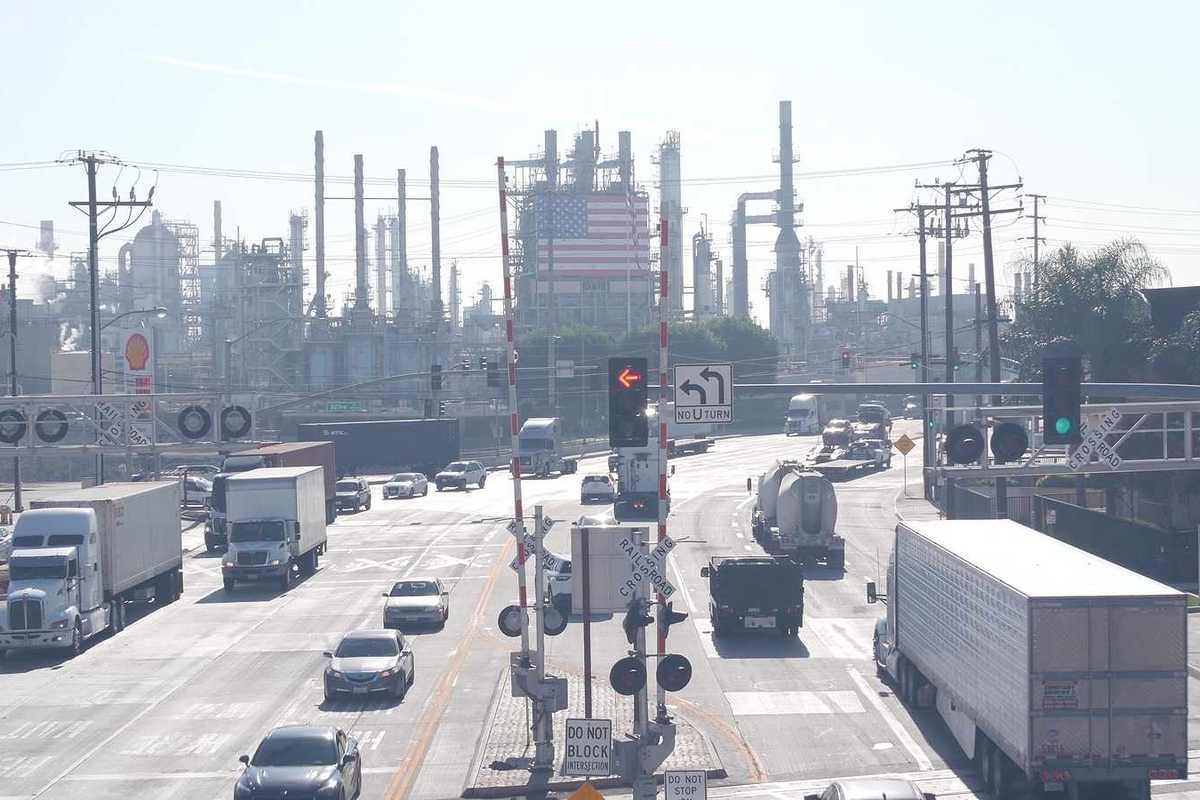 Marathon oil refinery, Los Angeles. Petroleum, chemicals and gasoline factory. American flag and smokestacks of industrial petrochemicals plant.