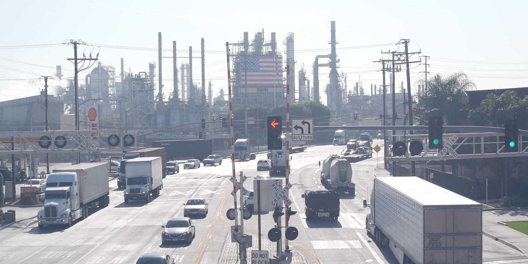 Marathon oil refinery, Los Angeles. Petroleum, chemicals and gasoline factory. American flag and smokestacks of industrial petrochemicals plant.