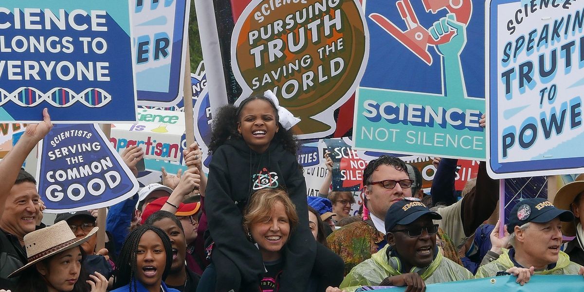 March for science participants holding signs.