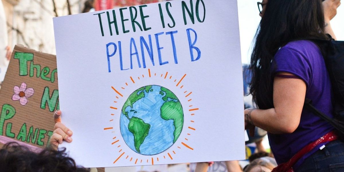 Marching for climate with sign:  "There Is No Planet B"