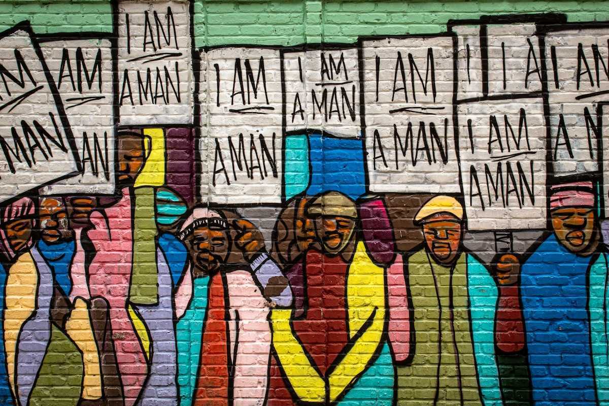 Mural on a building in Memphis painted during the Civil Rights movement, depicting black men holding signs that read "I am a man."