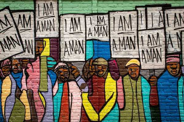 Mural on a building in Memphis painted during the Civil Rights movement, depicting black men holding signs that read "I am a man."