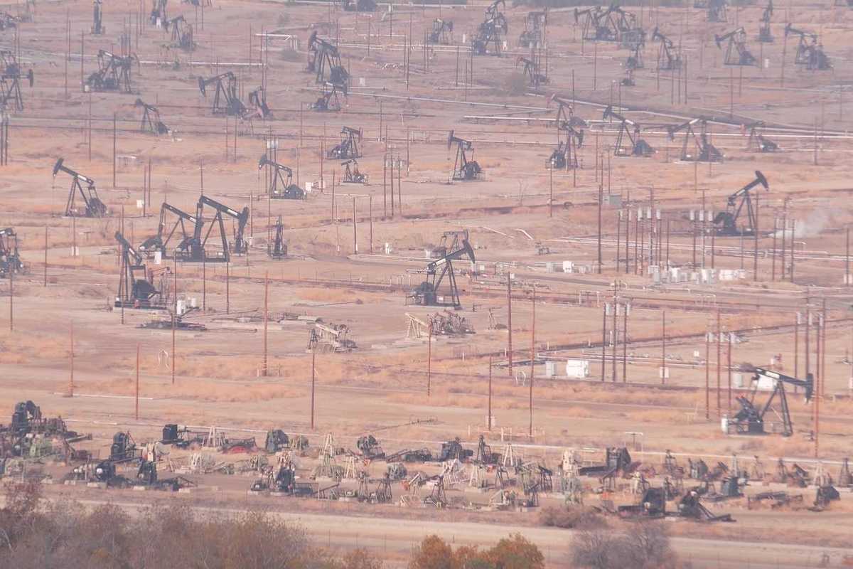 Myriad pump jacks working a crowded California oil field.