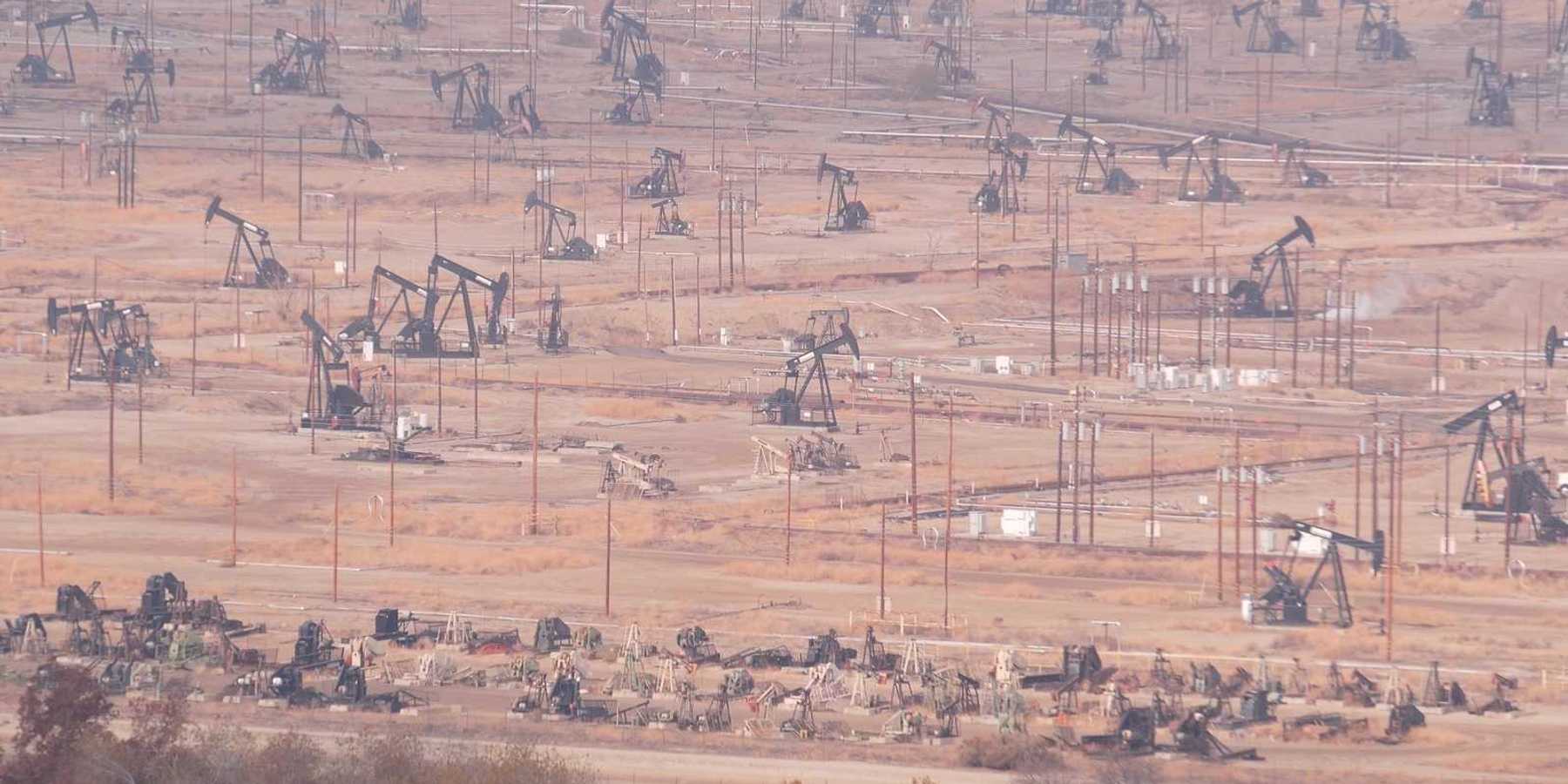 Myriad pump jacks working a crowded California oil field.
