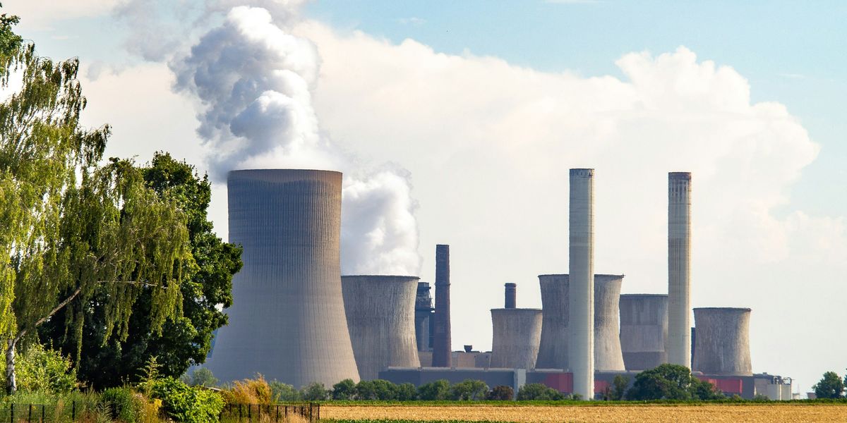 Nuclear power plant emitting steam from cooling towers.