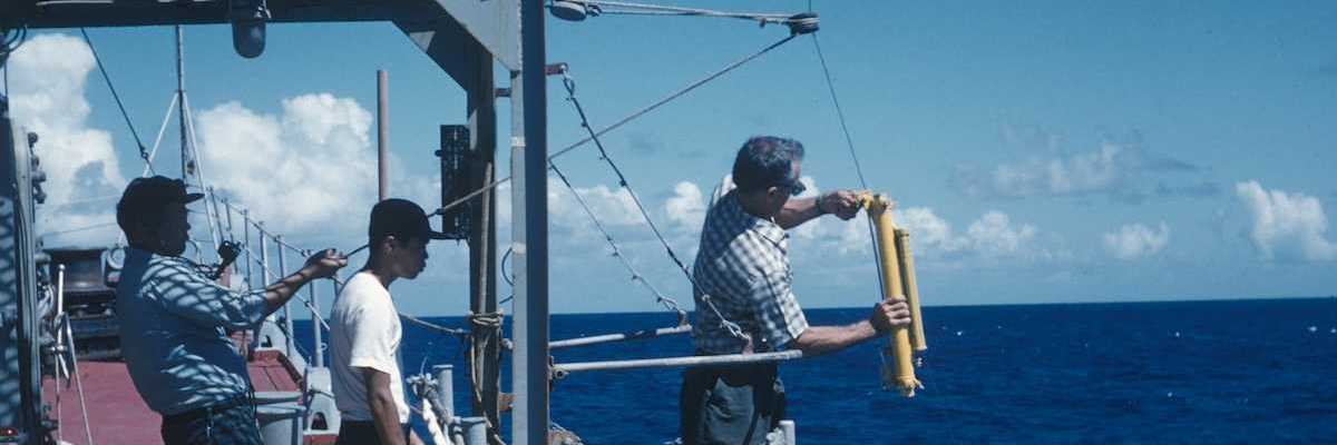Oceanographic operations on the Coast and Geodetic Survey Ship PIONEER. Attaching Nansen water sampling bottle and thermometer to wire.