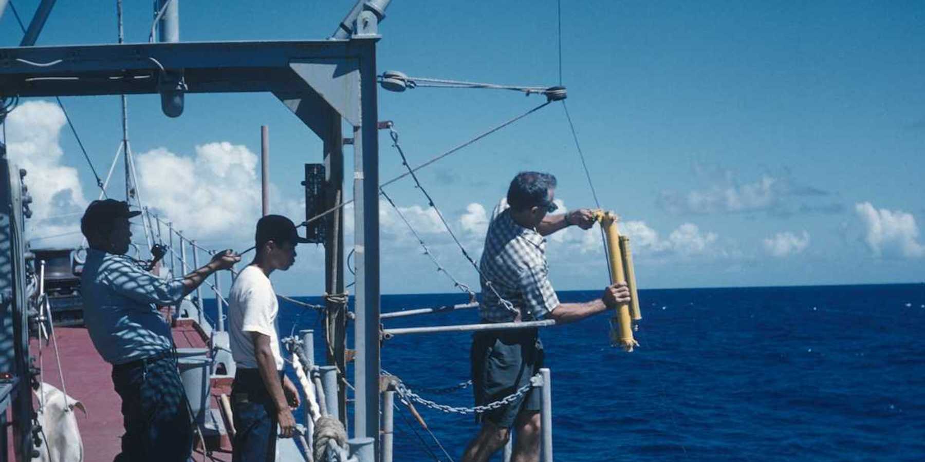 Oceanographic operations on the Coast and Geodetic Survey Ship PIONEER. Attaching Nansen water sampling bottle and thermometer to wire.