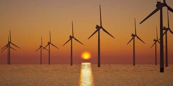 off shore wind farm against setting sun