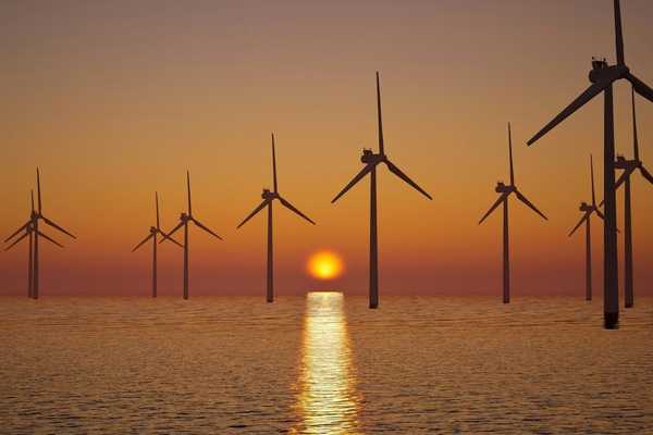 off shore wind farm against setting sun