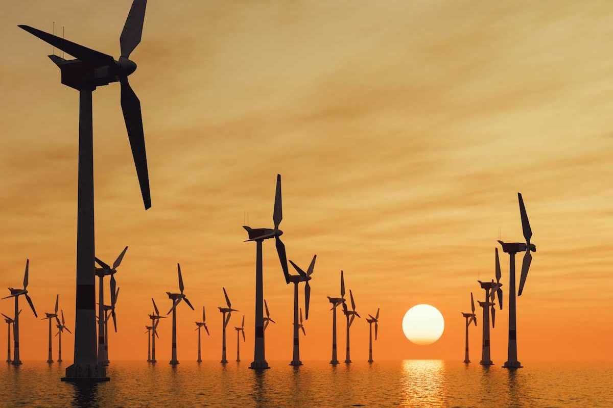 Offshore wind turbines against a setting sun