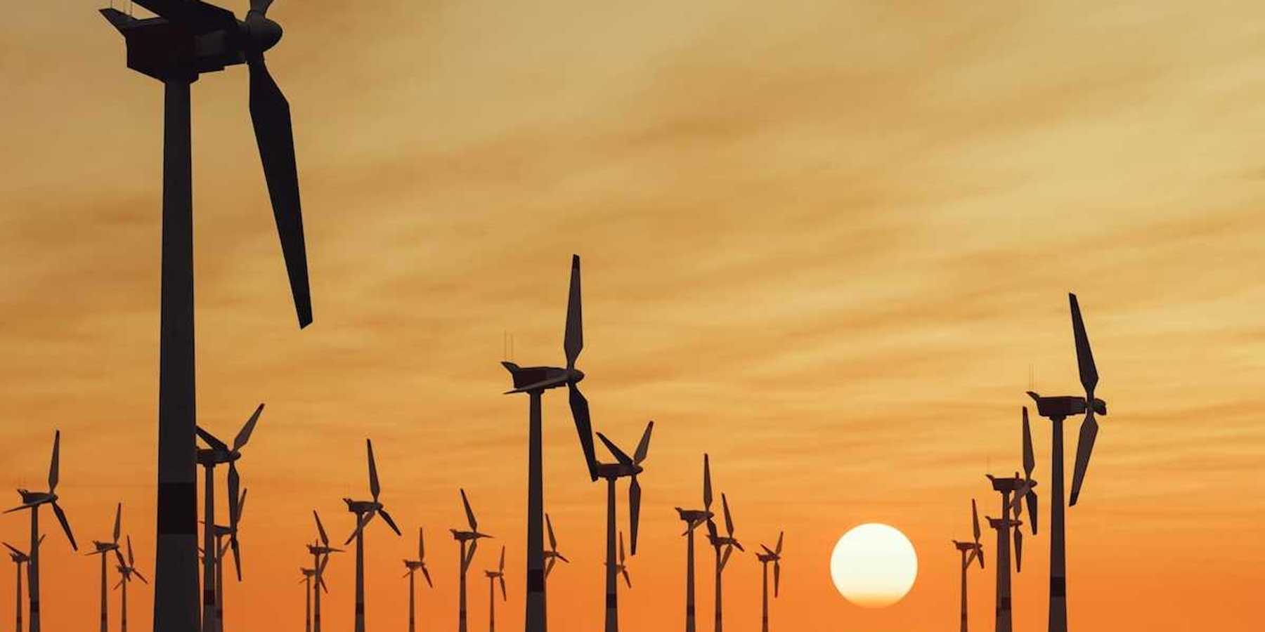 Offshore wind turbines against a setting sun
