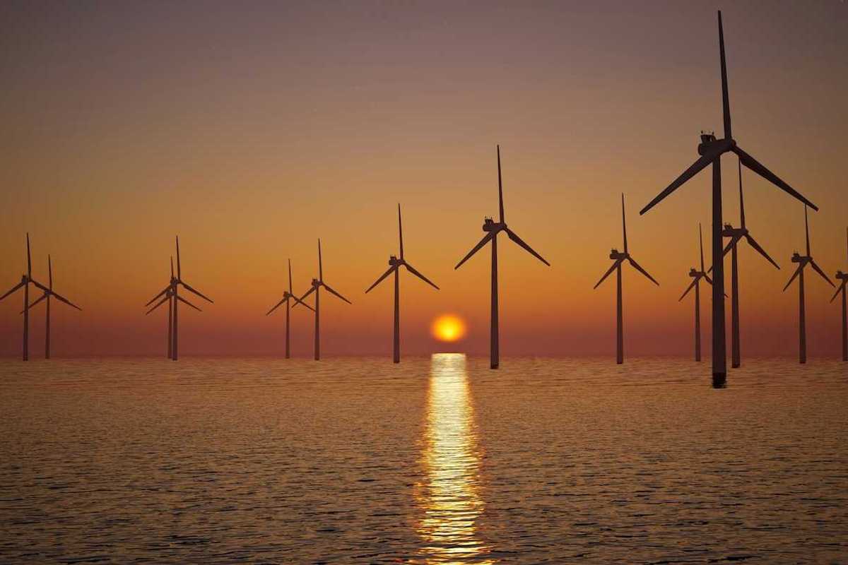 Offshore wind turbines against setting sun