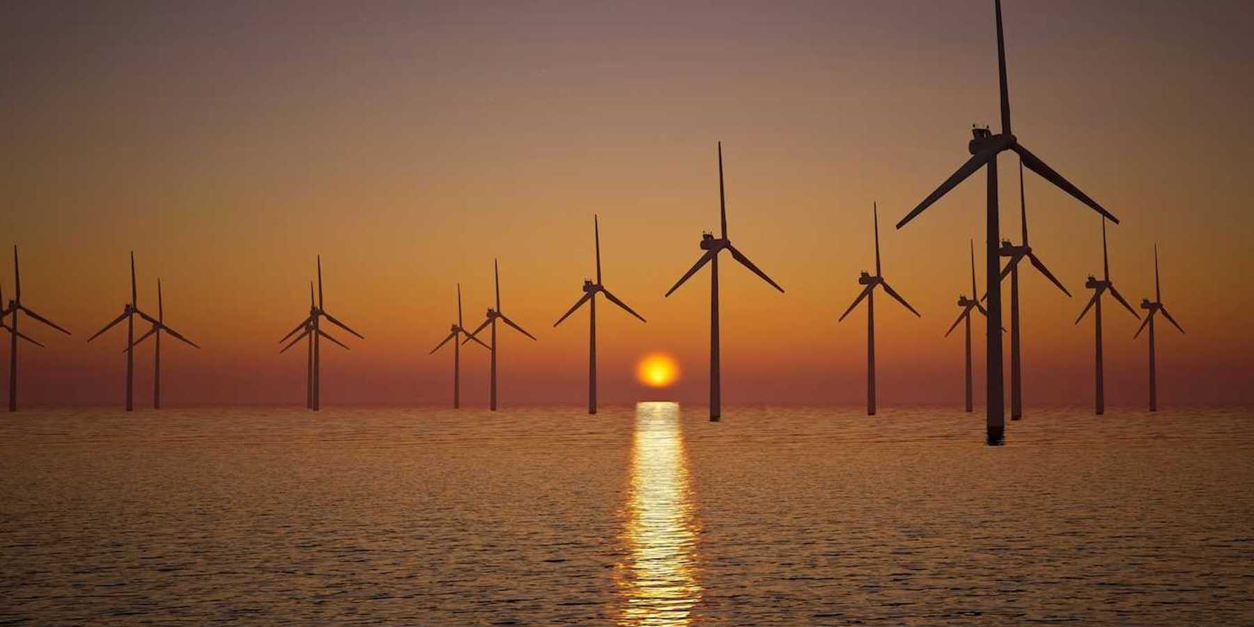 Offshore wind turbines against setting sun