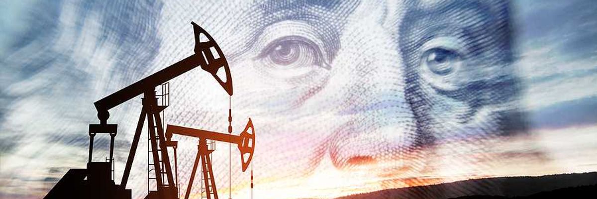 Oil pump jacks with an image of Benjamin Franklin in the background