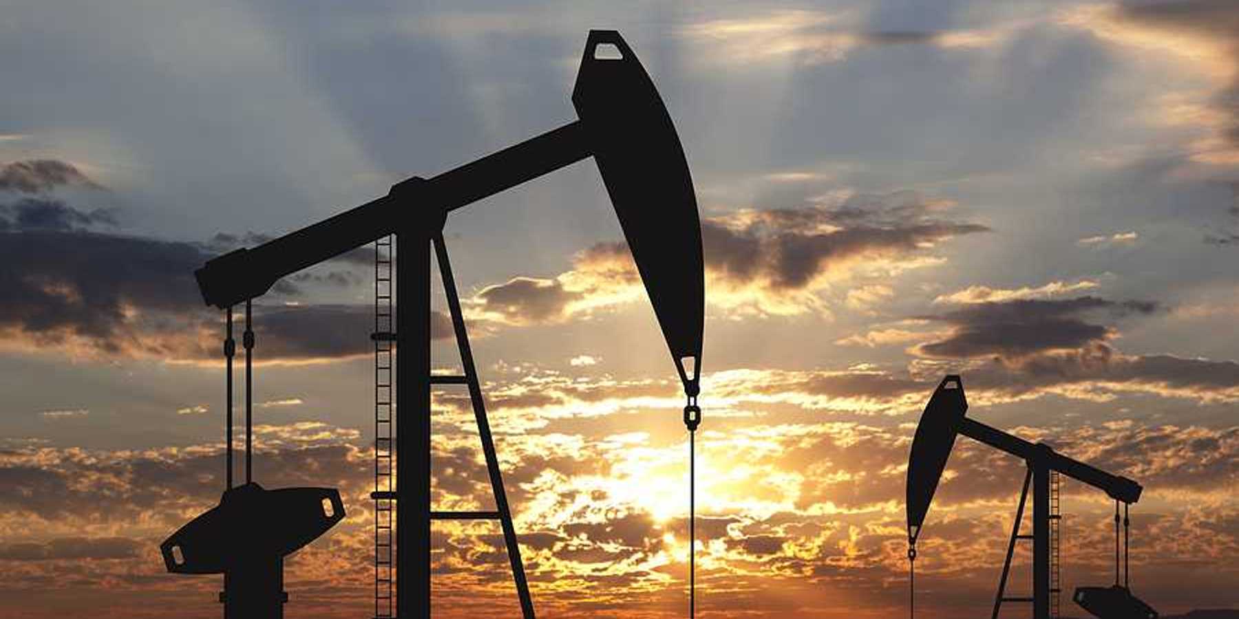 Oil pump oil rig energy industrial machine for petroleum in the sunset background