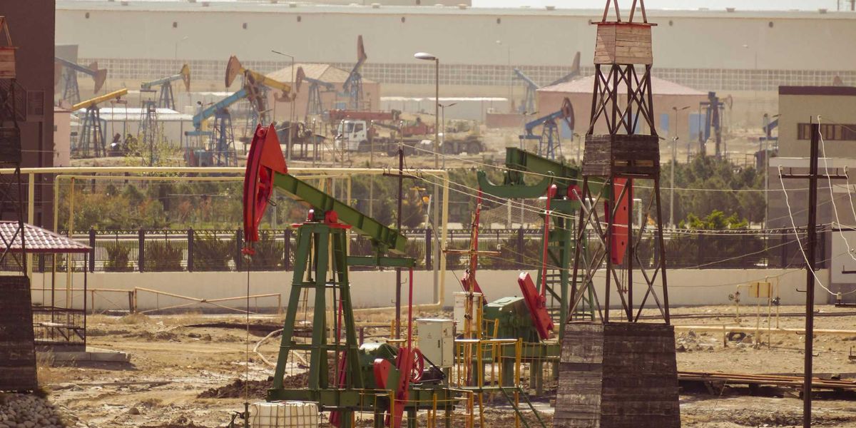 Oil pumps are operating in an industrial landscape.