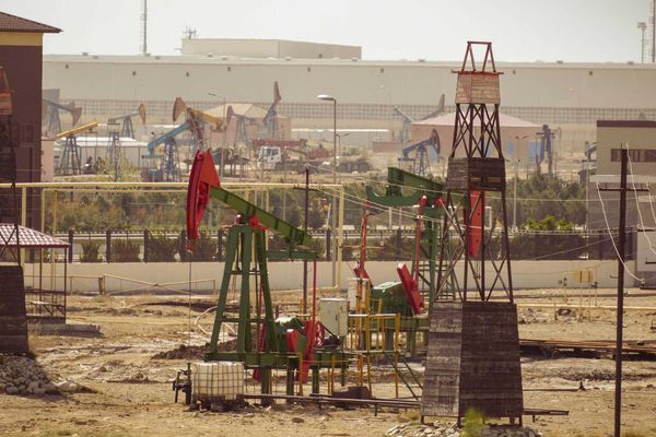 Oil pumps are operating in an industrial landscape.