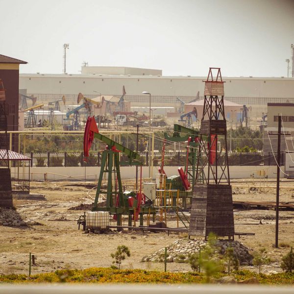 Oil pumps are operating in an industrial landscape.