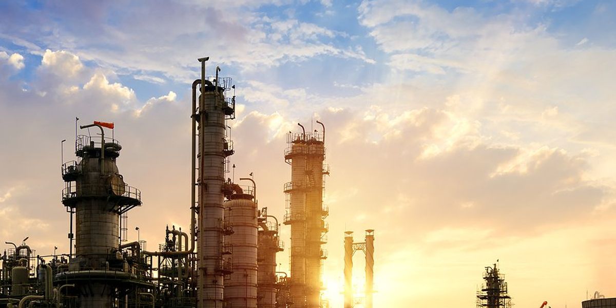 Oil refinery against a setting sun.