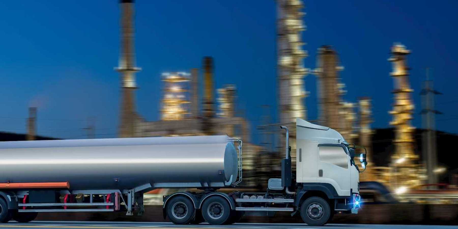 Oil tanker truck in front of a refinery