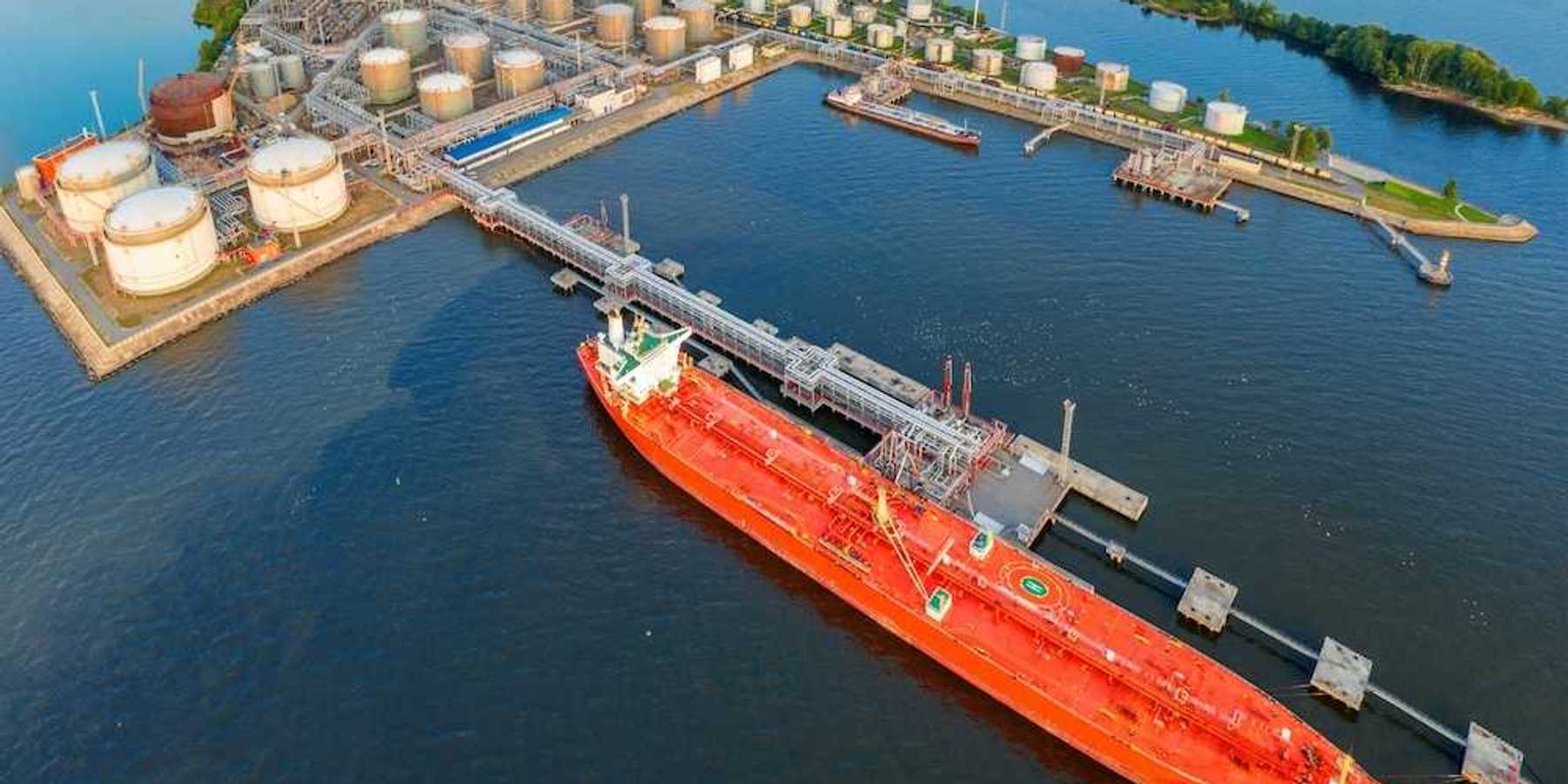 Oil tankers at a terminal full of storage tanks