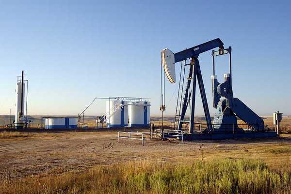 Oil well and storage tanks in the Texas panhandle.