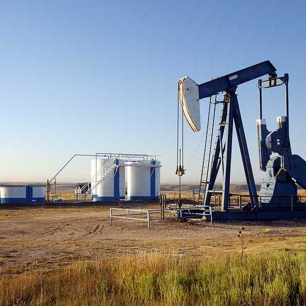 Oil well and storage tanks in the Texas panhandle.