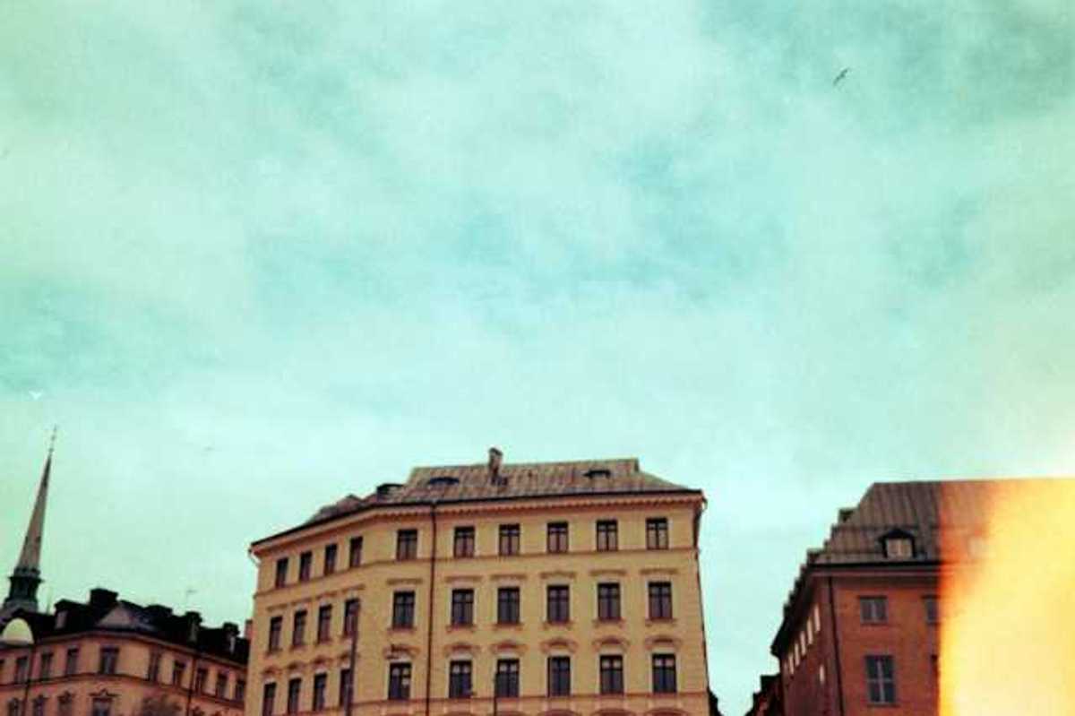 Old buildings stand against a bright blue sky