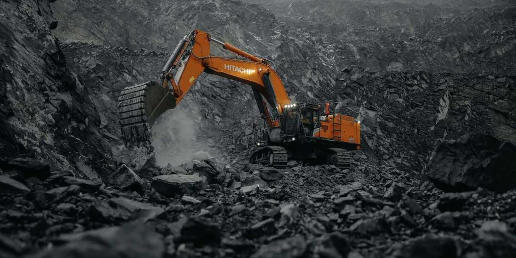 Orange Hitachi excavator working a coal mine.