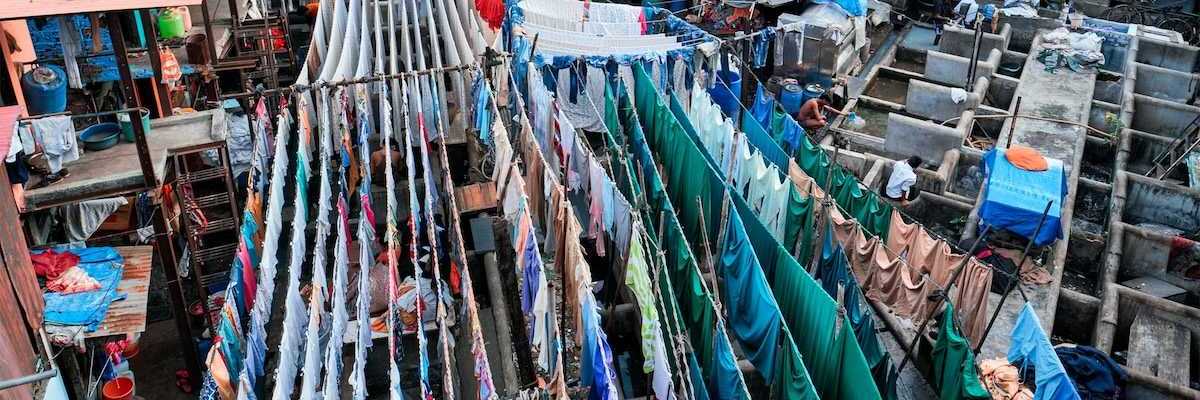 Outdoor textile market. Many textiles hanging on multiple lines