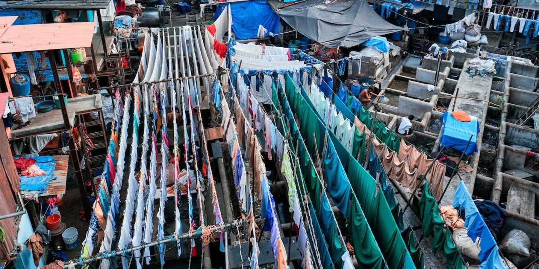 Outdoor textile market. Many textiles hanging on multiple lines