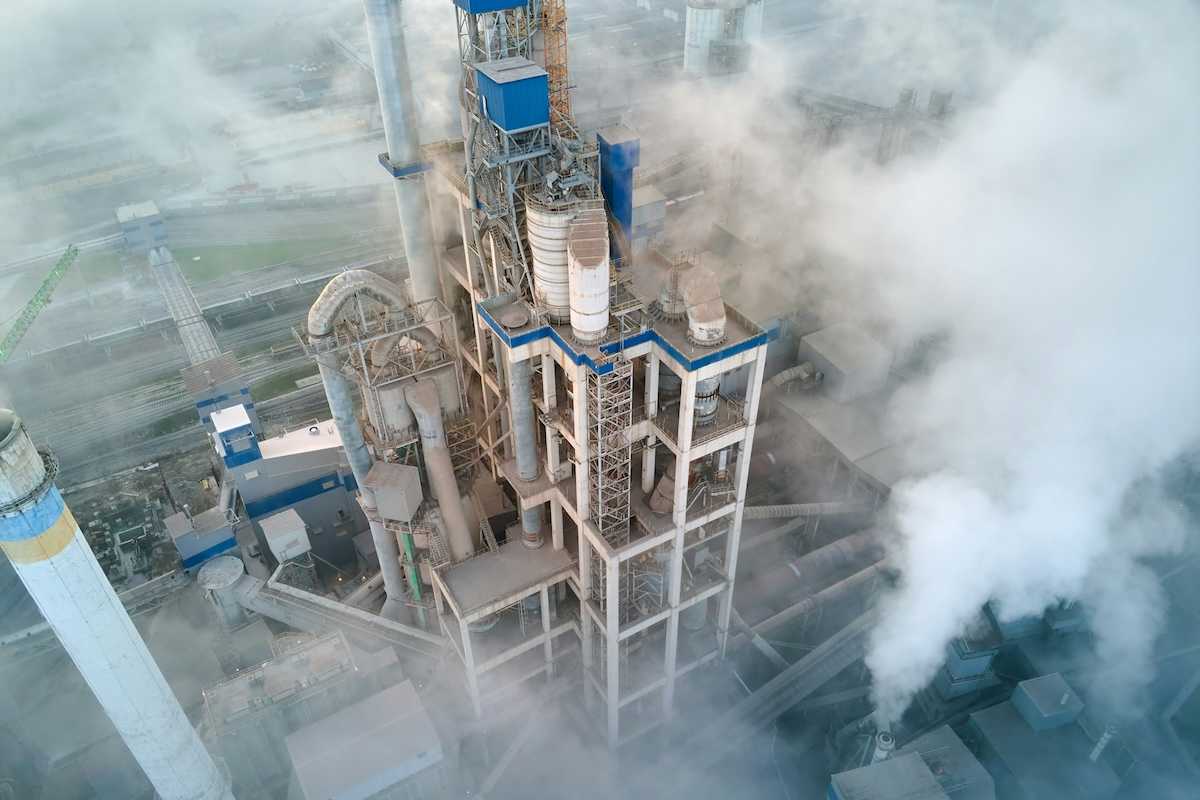 Overhead shot of a cement making facility engulfed in emissions