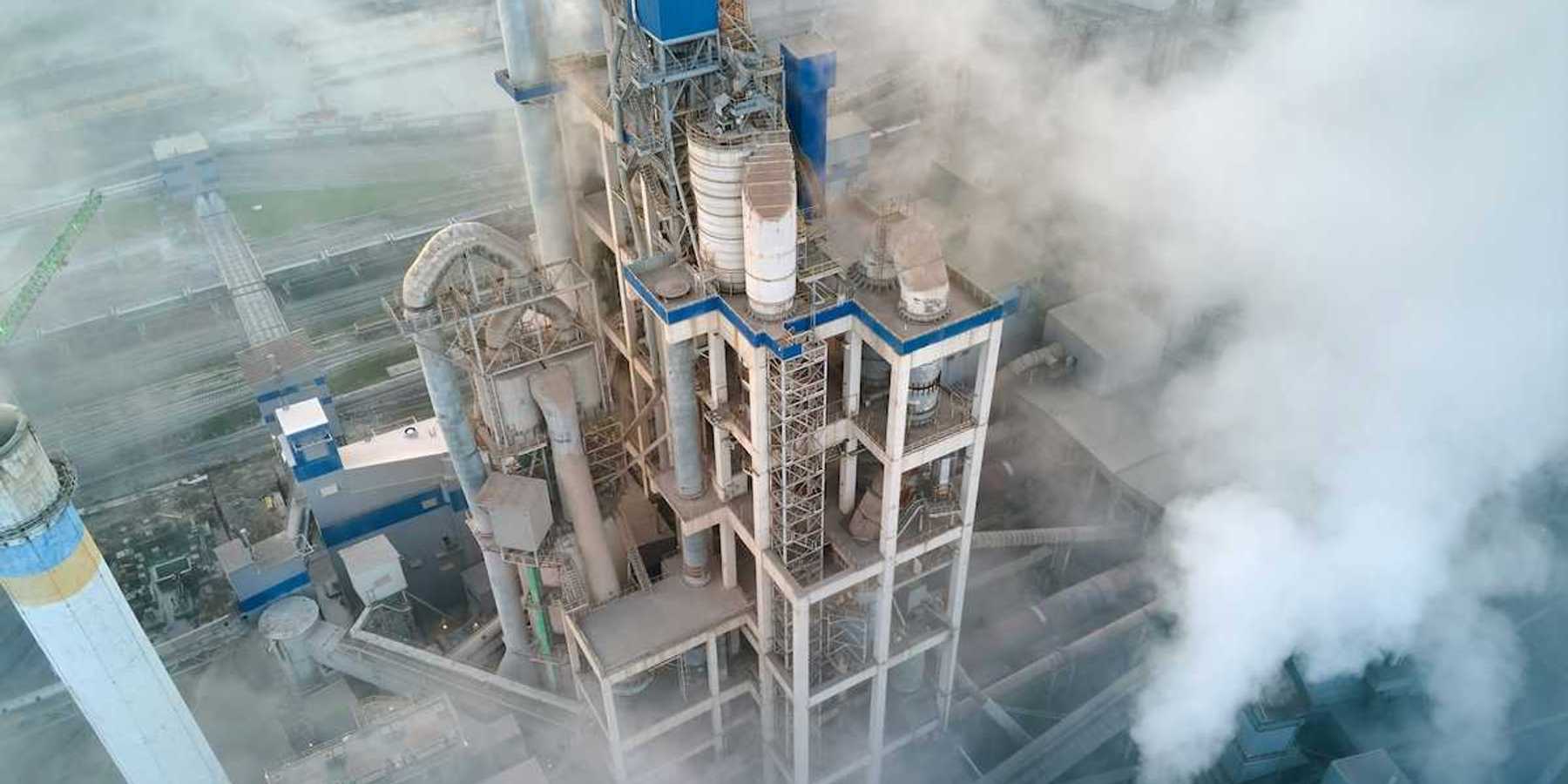 Overhead shot of a cement making facility engulfed in emissions