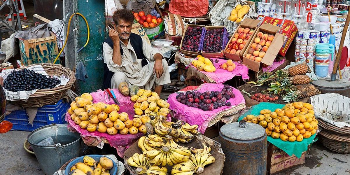 Pakistani man selling fruit on the street.