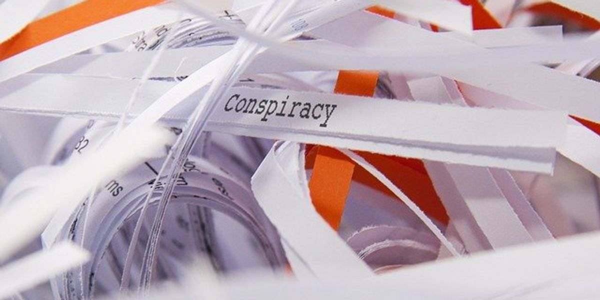 paper slip that says conspiracy